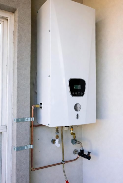 Wall-mounted tankless water heater illustrating routine maintenance and service scheduling
